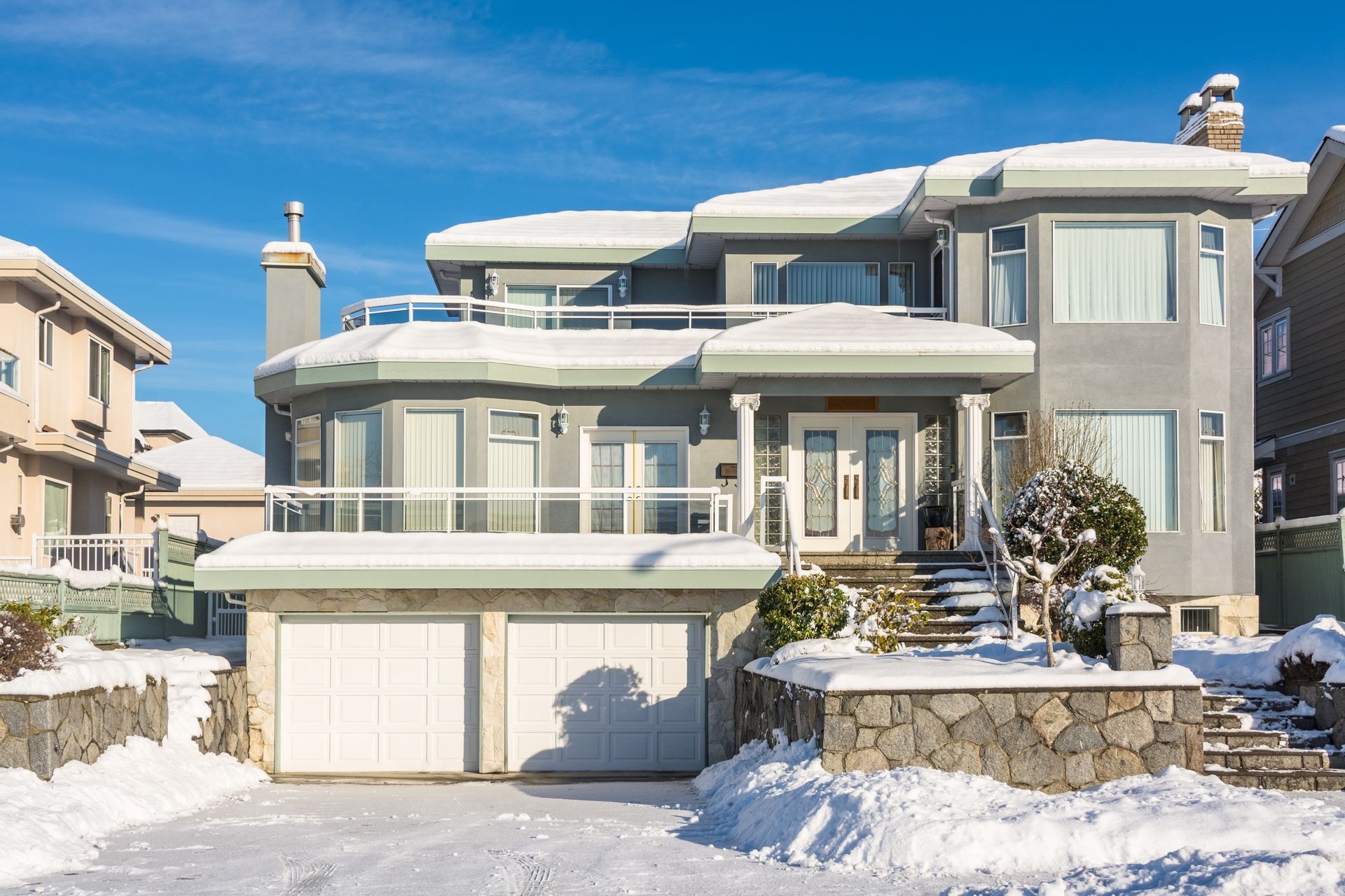 Big luxury residential house in winter season. North American family house on winter sunny day